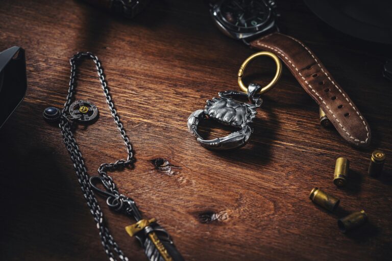 Hunting accessories flat lay with leather strap and bullet casings on dark wood